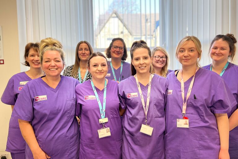 Image of nurses wearing purple uniform