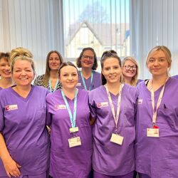 Image of nurses wearing purple uniform