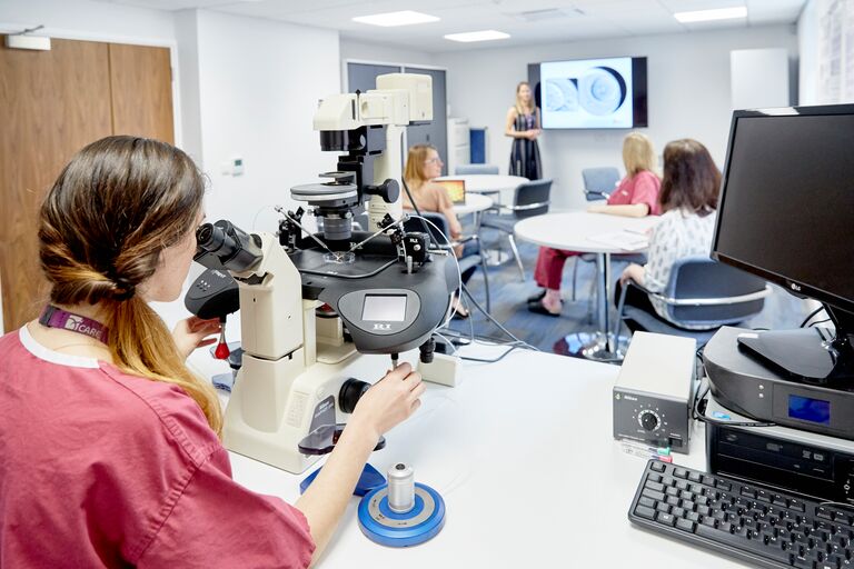 Examining under a microscope in Care Fertility Manchester
