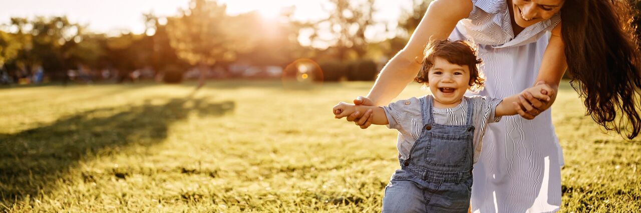 Mother and child playing in spring field