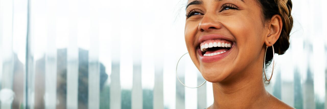 black woman with braided hair smiling